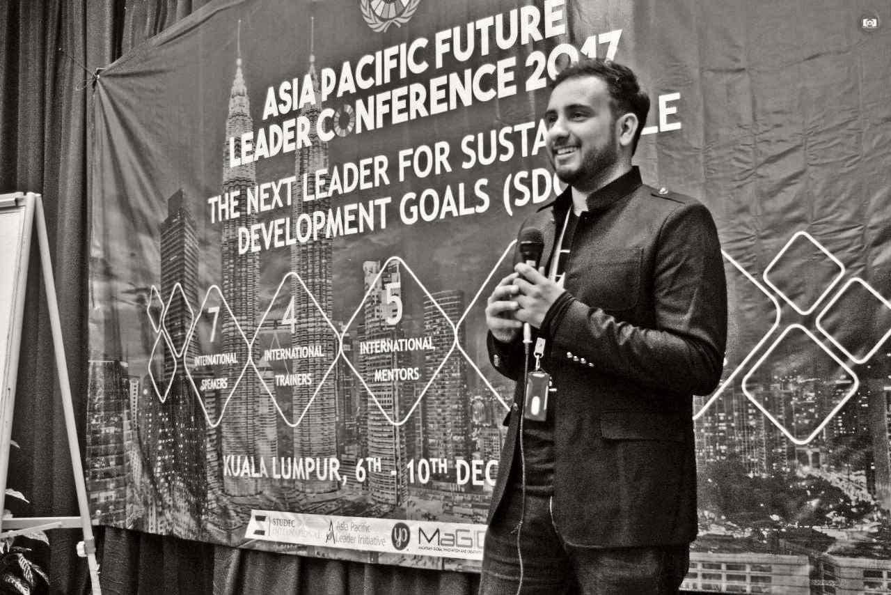 Moeid Saleem Khan speaking at a conference